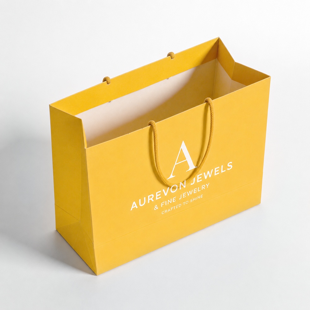 Unbranded paper shopping bags with rope handles arranged for a retail packaging display
